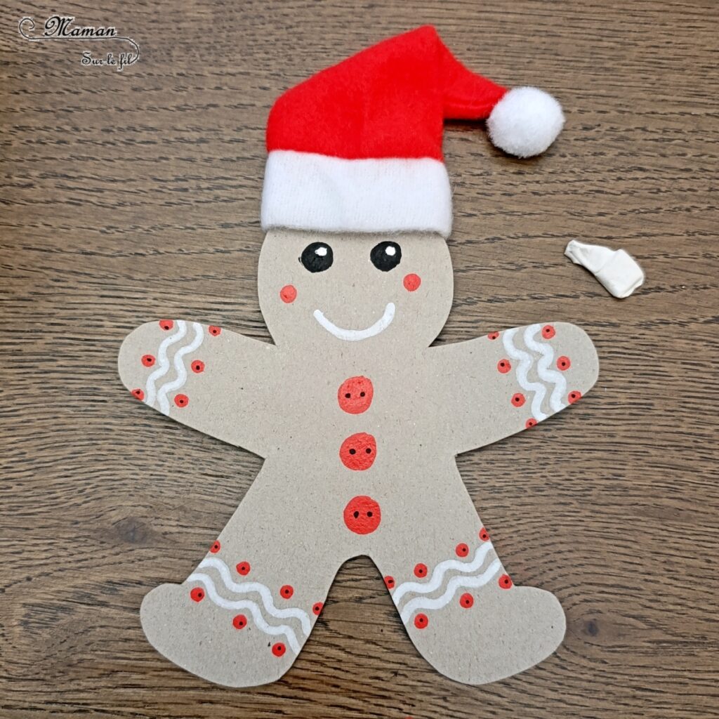 Fabriquer un bonhomme en pain d'épices en récup' avec son petit cadeau dans les bras : activité créative, récup' et manuelle enfants - Bricolage et décoration en carton - Découpage, dessin, graphismes, bonnet de Noël - Suspension DIY pour le sapin -Fait Maison - Thème Noël, hiver, gourmandises - Bricolage et décoration sympa et facile - Arts visuels Maternelle et cycle 2 - Maternelle et élémentaire - Créativité - Cycle 1 ou 2 - tutoriel photos - mslf