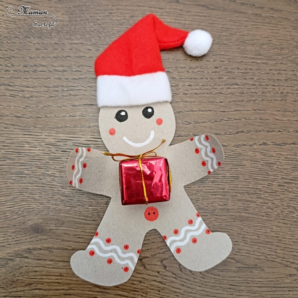 Fabriquer un bonhomme en pain d'épices en récup' avec son petit cadeau dans les bras : activité créative, récup' et manuelle enfants - Bricolage et décoration en carton - Découpage, dessin, graphismes, bonnet de Noël - Suspension DIY pour le sapin -Fait Maison - Thème Noël, hiver, gourmandises - Bricolage et décoration sympa et facile - Arts visuels Maternelle et cycle 2 - Maternelle et élémentaire - Créativité - Cycle 1 ou 2 - tutoriel photos - mslf