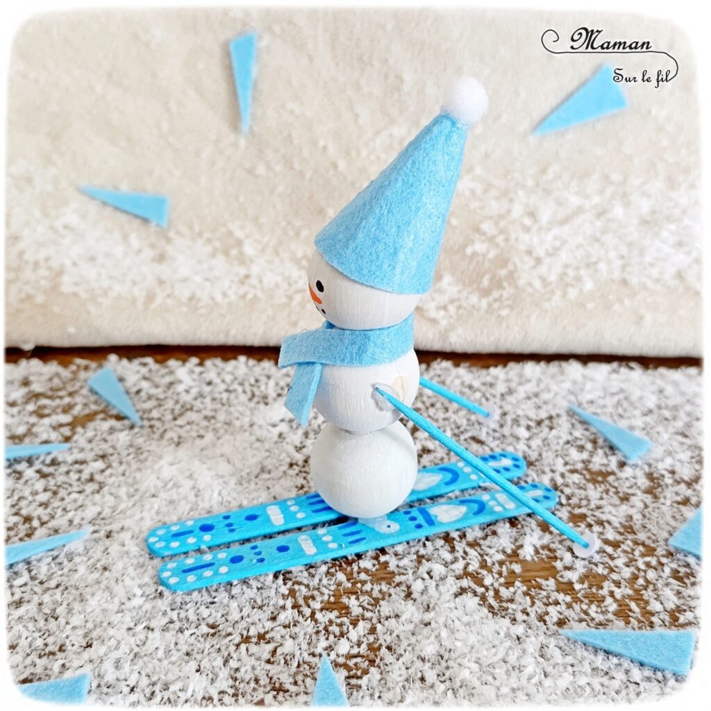 Fabriquer un bonhomme de neige qui fait du ski : activité créative et manuelle enfants - Bricolage avec des perles, des bâtonnets de glace en bois et de la feutrine - Récup, recyclage, surcyclage - Décoration hivernale - Thème hiver, montagne, neige, sports d'hiver - Bricolage et décoration sympa et facile - Arts visuels Maternelle et cycle 2 - Maternelle et élémentaire - Créativité - Cycle 1 ou 2 - tutoriel photos - mslf